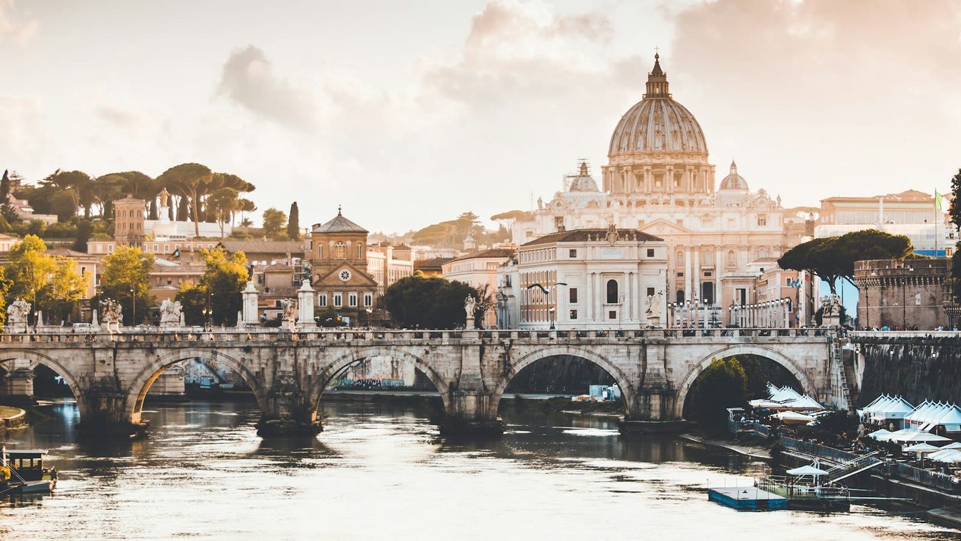 St. Peter's Basilica at sunrise with pilgrims at Vatican